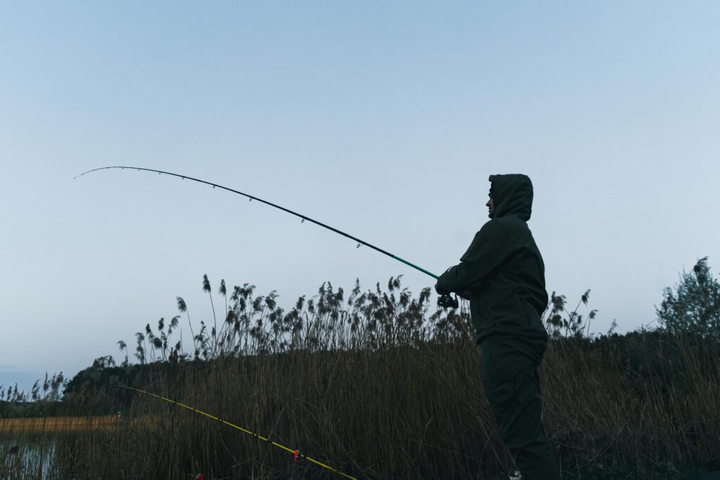Man fishing by the reeds at Krinitsa, Belarus during the day.
